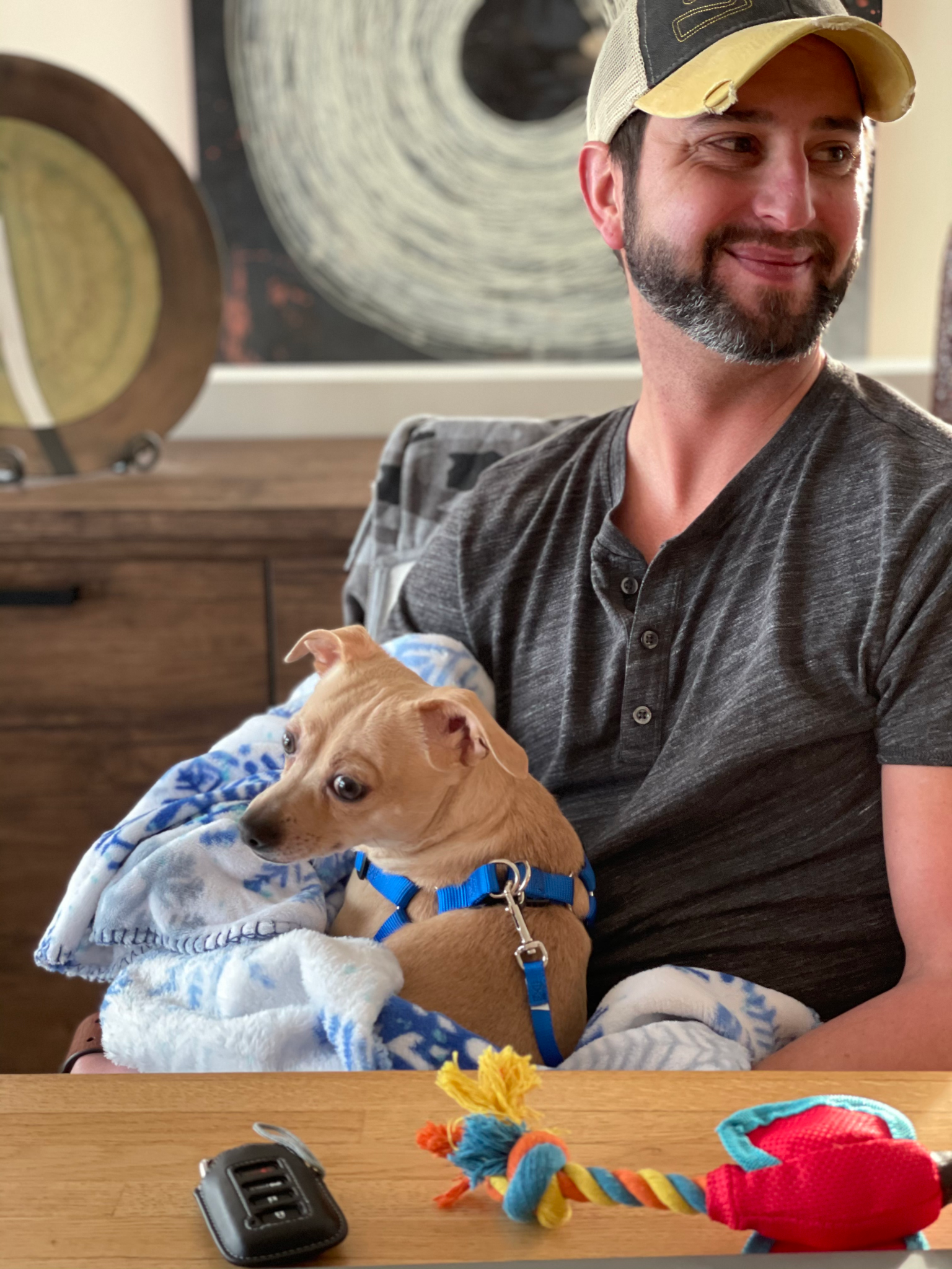 Adam relaxing at home with a small dog