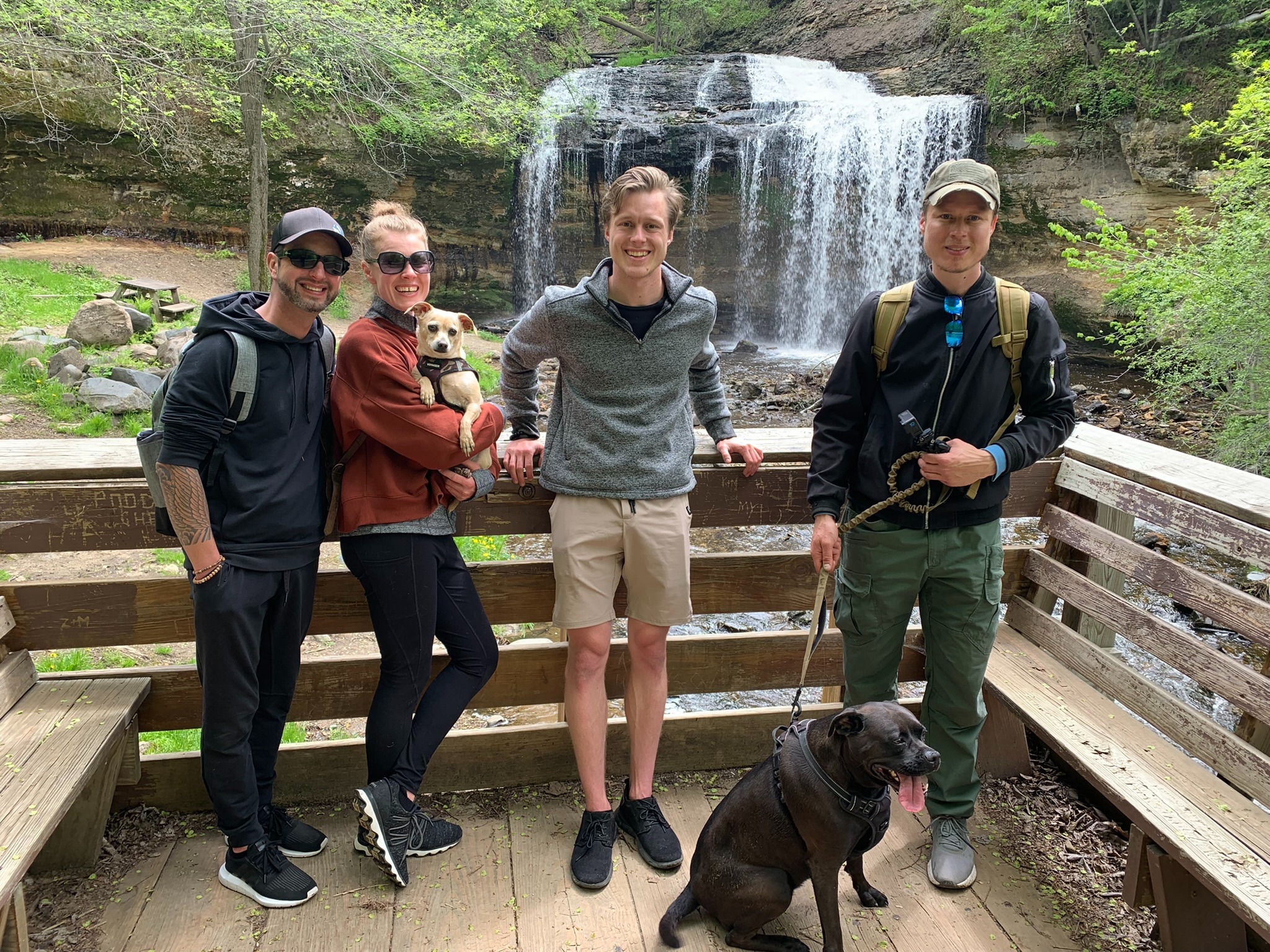 Adam spending time outdoors with friends at a waterfall