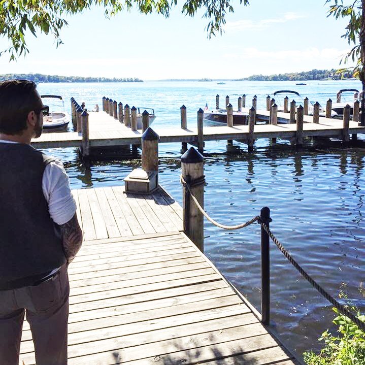Adam looking out over a lakeside dock
